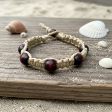 Load image into Gallery viewer, A Surfer Hemp Bracelet with flat wooden beads and a braided loop closure, displayed on a patterned surface.