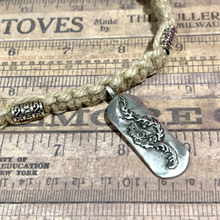 Load image into Gallery viewer, A handcrafted thick hemp necklace with a surfboard pendant, displayed on a background with printed text.