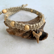 Load image into Gallery viewer, A handcrafted surfer-style thick hemp necklace with flat knots and a large shark tooth pendant, displayed on a wooden surface.