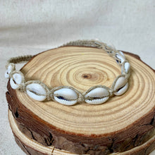 Load image into Gallery viewer, Necklace with white shell beads on a wooden surface
