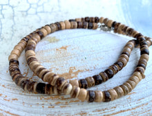 Load image into Gallery viewer, Necklace with brown and beige beads on a textured white surface
