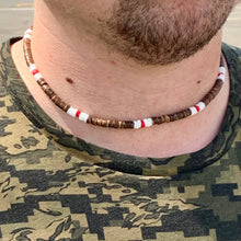 Load image into Gallery viewer, A close-up image of a person wearing a beachy choker necklace with red and brown beads.
